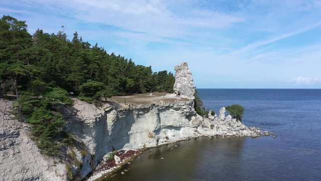 Flying towards edge of cliffs on an island, Aerial ascending