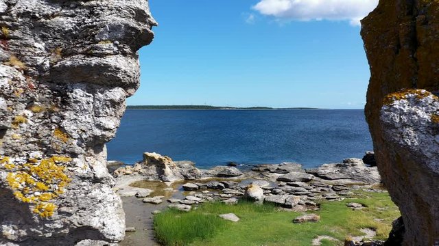 Cinematic shot between limestone formation rocks, Aerial pull back