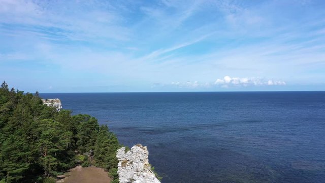 Limestone cliff at Gotland, surrounded by forest, Pull back aerial