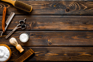 Barbershop concept. Hairdressing tools on dark wooden background top view space for text