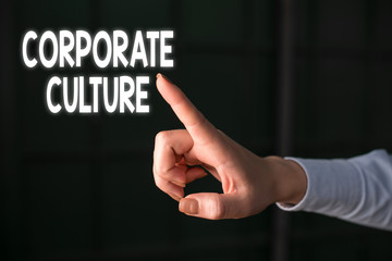 Writing note showing Corporate Culture. Business concept for pervasive values and attitudes that characterize a company Finger pointing in the Dark with hand pointing in the copy space