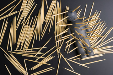 .Voodoo Doll on a black background with dramatic lighting.