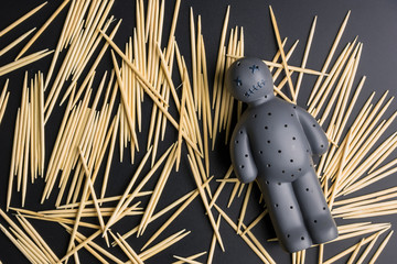 Voodoo Doll on a black background with dramatic lighting.