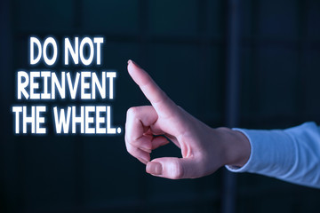 Writing note showing Do Not Reinvent The Wheel. Business concept for stop duplicating a basic method previously done Finger pointing in the Dark with hand pointing in the copy space
