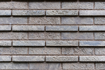 Closed up grey brick wall texture. Architectural material construction.