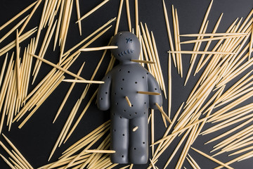 .Voodoo Doll on a black background with dramatic lighting.