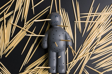 .Voodoo Doll on a black background with dramatic lighting.