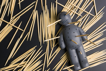 .Voodoo Doll on a black background with dramatic lighting.