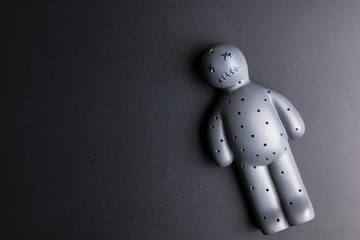 Voodoo Doll on a black background with dramatic lighting.