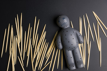 Voodoo Doll on a black background with dramatic lighting.