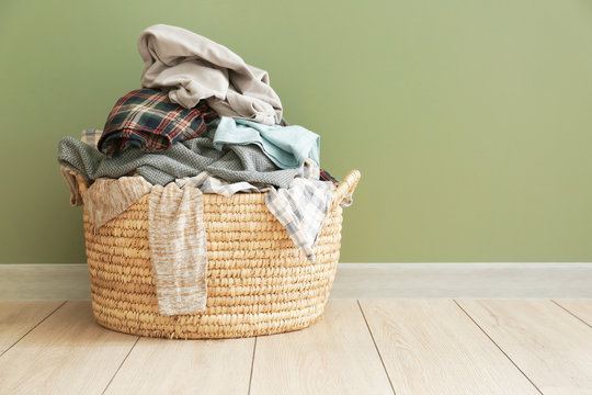 Basket with dirty laundry on floor