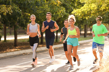 Obraz premium Group of sporty young people running outdoors