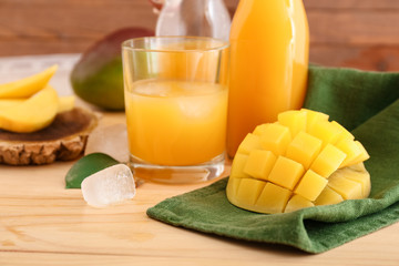 Composition with tasty mango juice on table