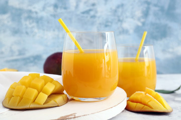 Glasses of fresh mango juice on table