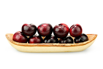 Group fresh plum on a wood plate isolated on white background.