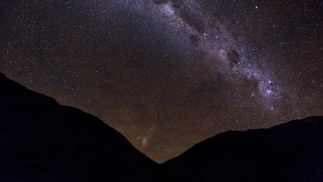 Time-lapse is showing a Milky Way with Magellanic Clouds rising over on the chilean Andes near Paso de Agua Negra.