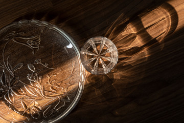 Crystal glass and plate in a beam of sunlight