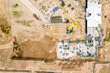 heavy building machinery working at construction site. top down aerial view