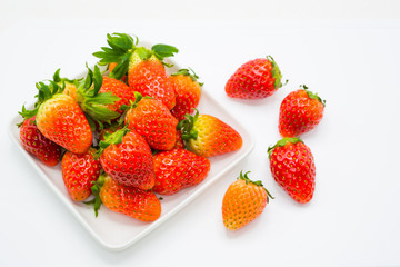 Fresh strawberry with plate on white background