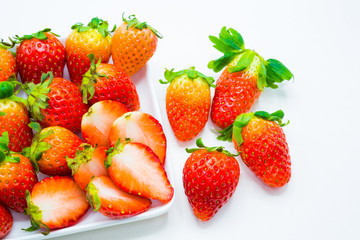 Fresh whole strawberry and half cutting with plate on white background