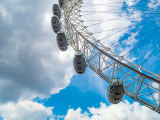 ferris wheel on blue sky with clouds
