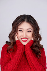 Portrait of beauty winter asian girl in red knitted woolen dress. Christmas Holiday.