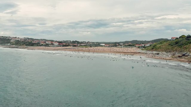 Aerial Shot of Ocean Shore with many Surfers, Swimmers and People on the Beach near Biarritz Beach Resort - Basque Country South West of France