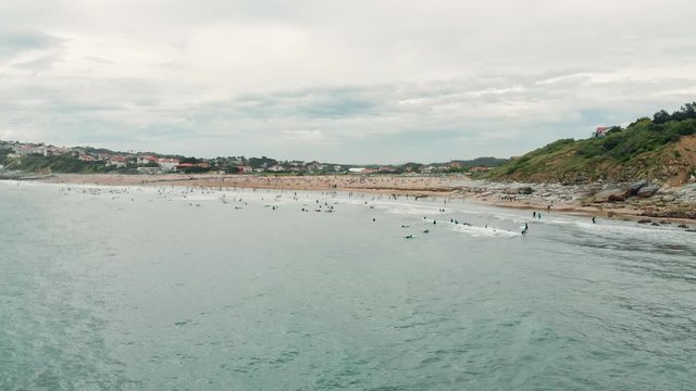 Aerial Shot of Ocean Shore with many Surfers, Swimmers and People on the Beach near Biarritz Beach Resort - Basque Country South West of France