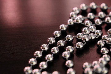 Silver Christmas decoration on a dark wooden background close up