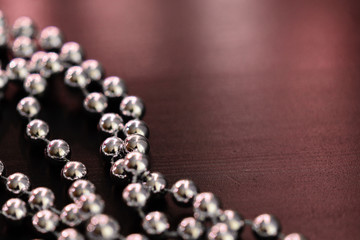 Silver Christmas decoration on a dark wooden background close up