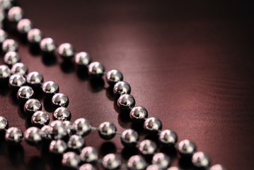Silver Christmas decoration on a dark wooden background close up