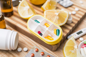 Yellow capsule container box with pills for daily take medicine