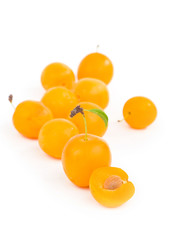 Yellow plum with leaves isolated on white background