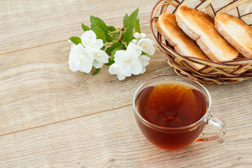 Glass cup of green tea with white jasmine flowers
