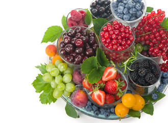 different summer berries red currant, gooseberry, raspberry in glass trays. sorted by type. superfoods from the garden