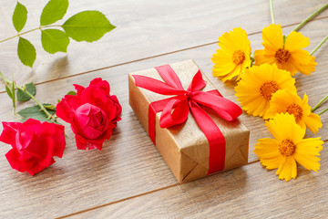 Gift box on wooden boards with flowers