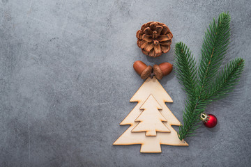 Decor wooden fir tree with branches on a stone background