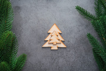 Decor wooden fir tree with branches on a stone background