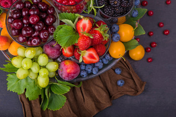 summer fresh berries of different types on a black background
