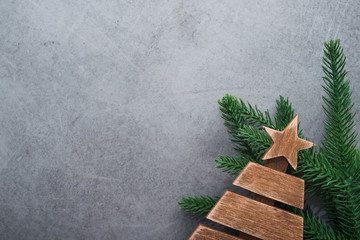 Decor wooden fir tree with branches on a stone background