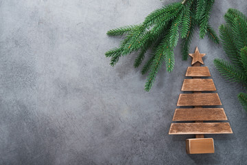 Decor wooden fir tree with branches on a stone background