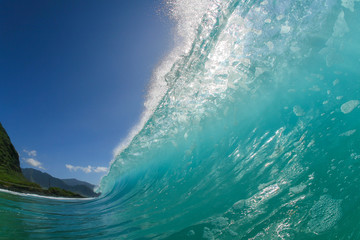 huge blue wave crashing on a beach
