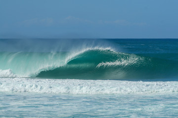 huge wave breaking on the beach at pipeline in hawaii