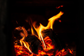 Fire is red in a closed oven on black background. 2019