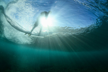 under water scene of a surfer on a wave