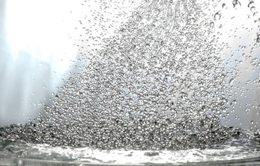 a lot of falling drops on a light background, like heavy rain