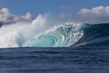 Massive foamy wave breaking at pipeline on the north shore of Oahu in Hawaii