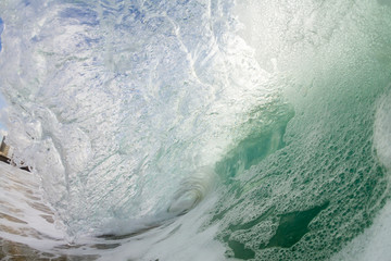 huge foamy wave breaking in the ocean 