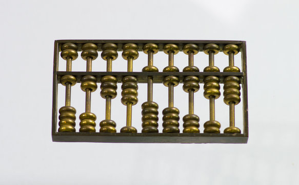 Chinese Abacus Ancient Antique Counting Machine In Bronze Metal. Chinese Abascus Hand Mechanical Calculating Machine. Close Up Isolated On Light Background.  