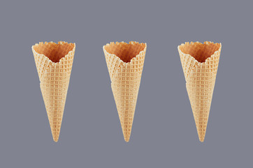 Set of three empty crisp ice cream cones on grey background, mock up for advertising, design, menu, summer food.